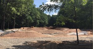 River's Edge Bike Park: a clay bike track with varying slopes, surrounded by trees