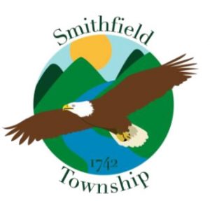 Smithfield Township seal: eagle flying through a mountain range and over a river.